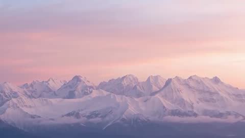 Mystical Dawn Over Snow-Capped Alpine Mountains
