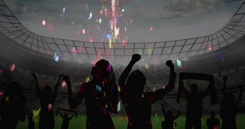 Silhouetted Fans Cheering in Stadium with Colorful Confetti Fall