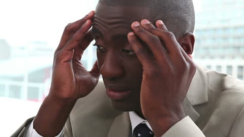 Businessman Expressing Stress at Workplace