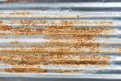 Rusty corrugated metal sheet with weathered texture