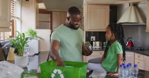 Father and Daughter Recycling Together in Kitchen - Download Free Stock Images Pikwizard.com
