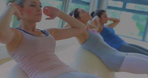 Women Exercising in Studio with Stability Balls