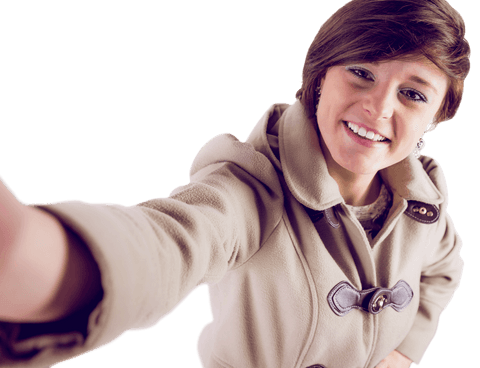 Smiling woman in winter coat taking selfie on transparent background