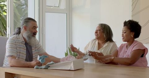 Aging parents and young woman celebrating pregnancy announcement