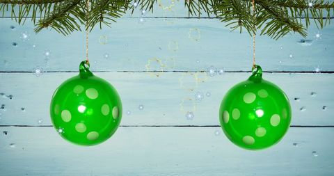 Festive Christmas Green Ornaments and Falling Snow - Download Free Stock Images Pikwizard.com
