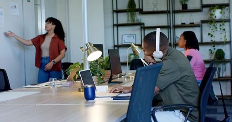 African american team presenting and collaborating in modern office during brainstorming