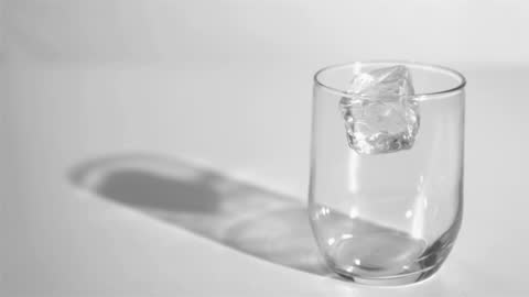 Single Ice Cube Splash in Clear Glass