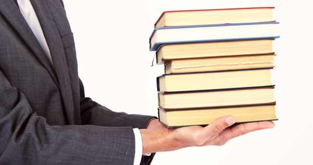 Businessperson Holding Stack of Books in Hand - Download Free Stock Images Pikwizard.com