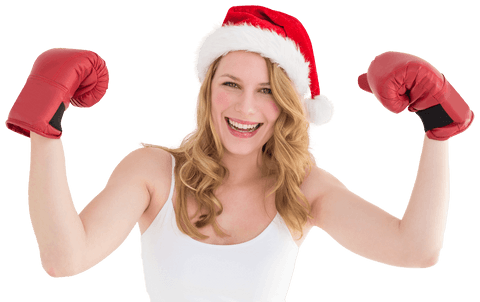 Festive blonde wearing santa hat raising boxing gloves transparent background