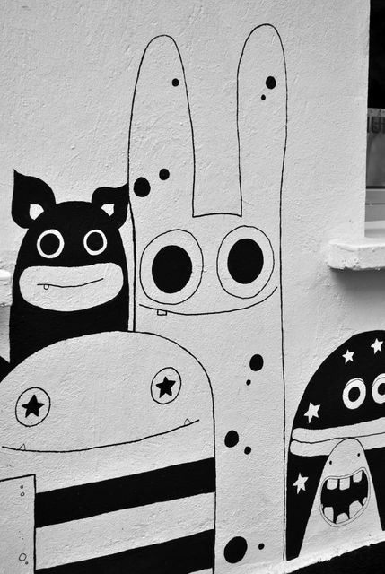 Creative mural showcasing abstract whimsical characters in black and white. Ideal for articles on urban art, street culture, modern public spaces, and artistic designs. Also suitable for decorating marketing materials, promoting art events, and engaging visual content for social media.