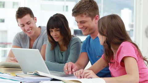 Happy Students Collaborating with Laptop in Bright Modern Campus