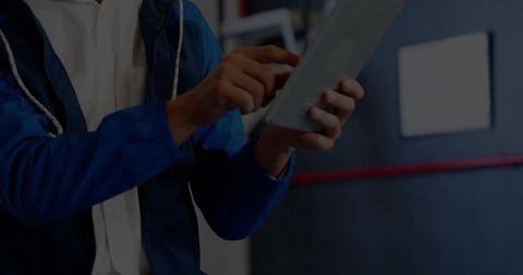 Technician using tablet in industrial workshop setting