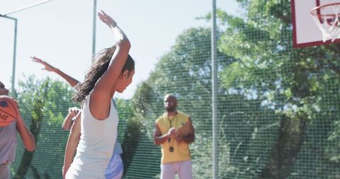 Female Basketball Team Training Outdoors on Sunny Day
