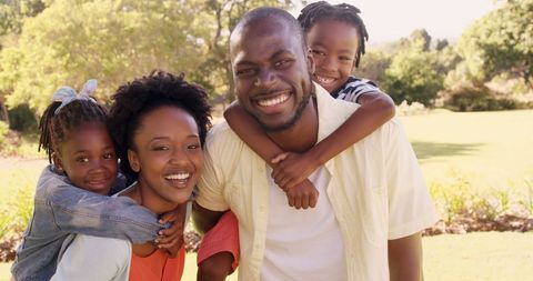 Joyful Family Embracing During a Sunny Day Outdoors