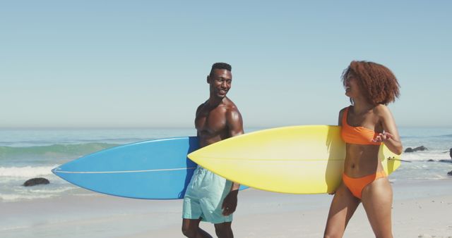 Young Couple Holding Surfboards Walking on Beach - Download Free Stock Images Pikwizard.com