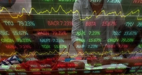 Businessman Analyzing Financial Charts with Trading Ticker Overlay