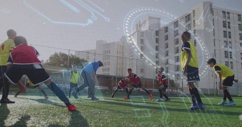 Soccer coach guiding boys stretching with futuristic overlay