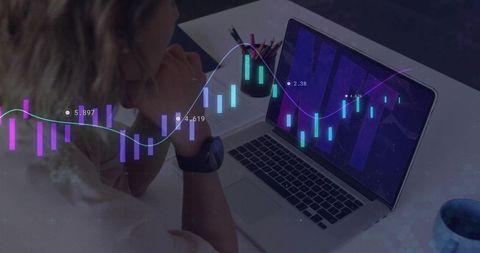 Businesswoman Analyzing Stock Market Graphs on Laptop