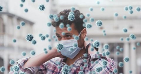 Man adjusting face mask with floating 3d virus particles