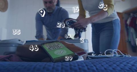 Mature couple packing suitcases checking qr health pass on smartphone before trip