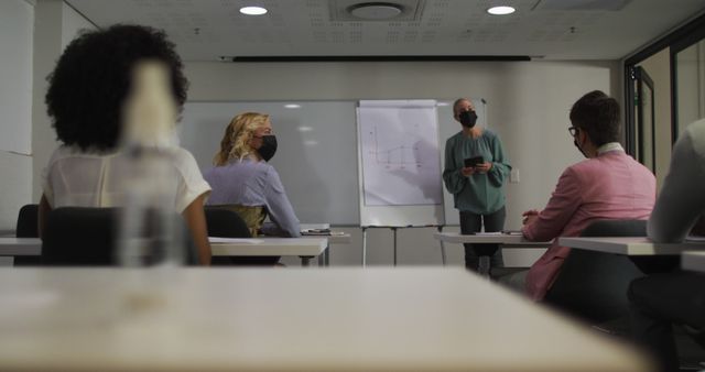 Masked Teacher Giving Presentation to Class in Modern Classroom - Download Free Stock Images Pikwizard.com