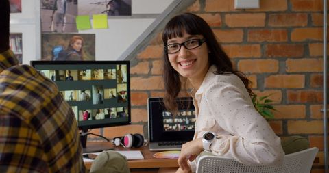 Caucasian female graphic designer smiling in modern office