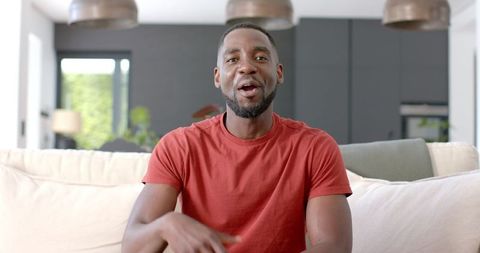 African American Man Relaxing and Smiling on Couch