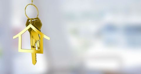 Golden House-Shaped Keychain with Metal Keys Lifestyle Concept