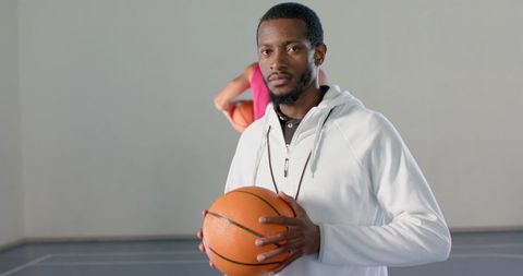 Basketball Coach Holding Ball in Indoor Practice Session - Download Free Stock Images Pikwizard.com
