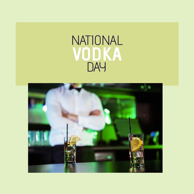 Professional bartender in white shirt and black bowtie standing behind the bar with hands crossed, with two glasses of vodka drinks garnished with lemon and served with straws in foreground. Ideal for promoting bar events, mixology classes, or social media posts celebrating National Vodka Day.