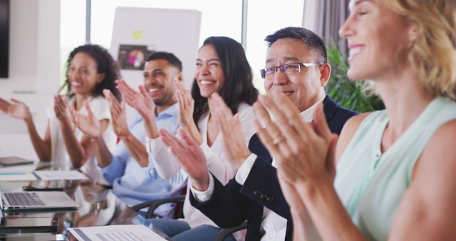 Happy diverse business people having meeting and clapping hands at office. Business, teamwork, communication and work.
