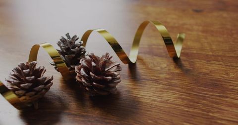 Festive pinecones with golden ribbon for christmas celebration