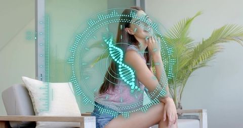 Young woman sitting touching chin with dna hologram overlay suggesting futuristic genetics