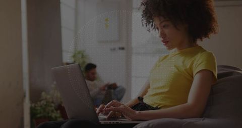 Focused Woman Typing on Laptop in Cozy Living Room