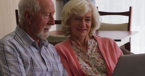 Older Couple Using Laptop at Home for Family Video Call