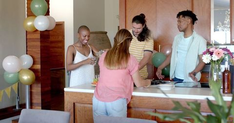Friends Enjoying Snack Selection During Intimate Home Celebration
