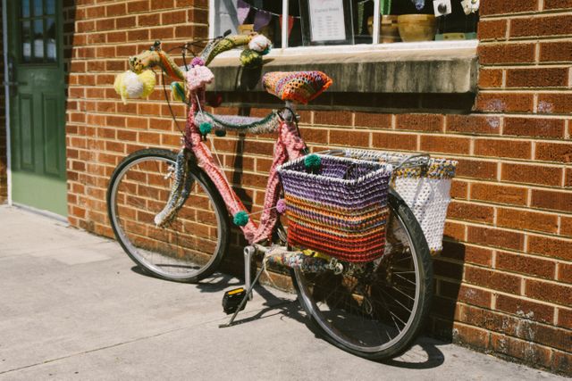 Colorful Yarn-Bombed Bicycle Against Brick Wall - Download Free Stock Photos Pikwizard.com