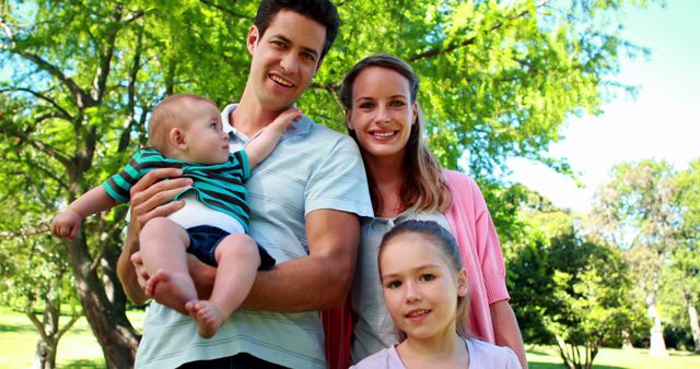 Happy Young Family Enjoying Time Outdoors in the Park on Sunny Day - Download Free Stock Images Pikwizard.com