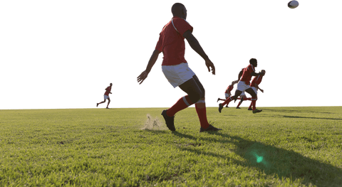 Transparent rugby game action; african american players on green field