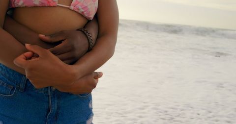 Couple Embracing on Beach at Sunset