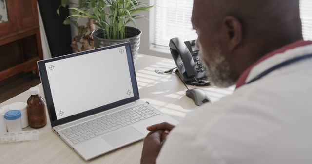 Doctor Working with a Blank Laptop Screen in Office - Download Free Stock Images Pikwizard.com