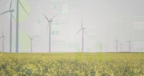 Wind turbines over canola field with digital chart overlays