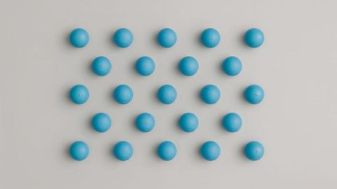Minimalist Geometric Grid of Small Blue Spheres with Neutral Backdrop