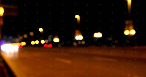 Blurred Urban Night Scene with Warm Streetlights