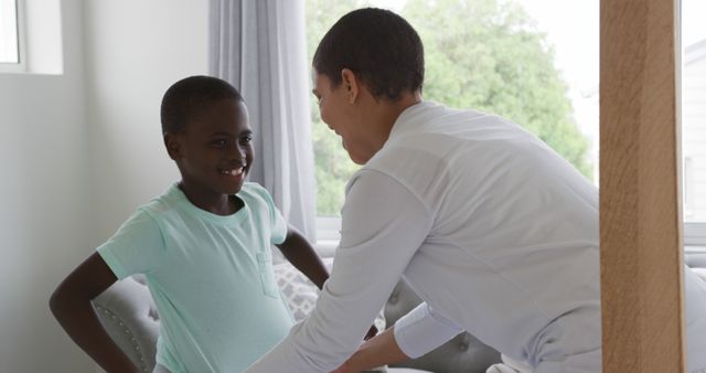 Mother Helping Son Dress in Bedroom with Natural Light - Download Free Stock Images Pikwizard.com