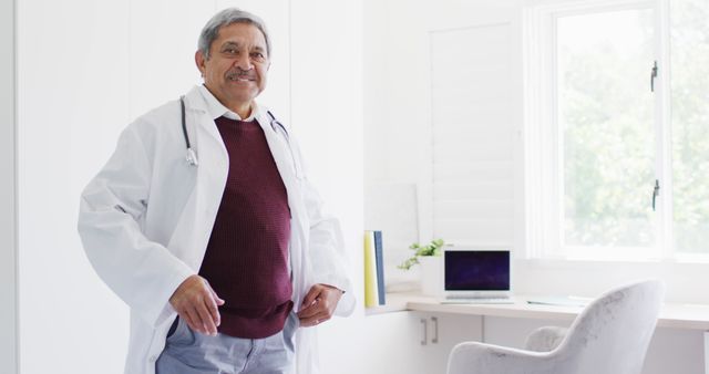 Smiling Senior Doctor in Office with Stethoscope - Download Free Stock Images Pikwizard.com