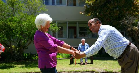 Senior Couple Enjoying Leisure Time in Sunny Yard