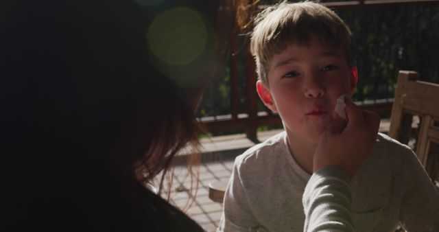 Mother cleaning young son's face outdoors - Download Free Stock Images Pikwizard.com