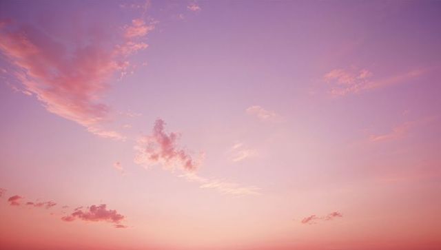 Pastel sky at dawn with pink and violet clouds