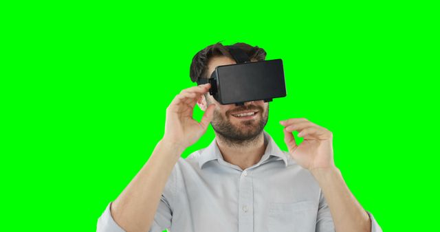 Man using virtual reality headset against green screen